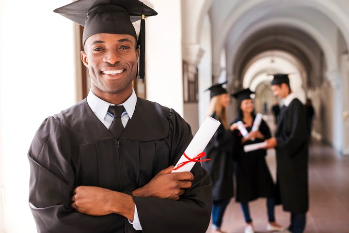 college graduate holding his diploma | Subaru of North Miami in Miami FL