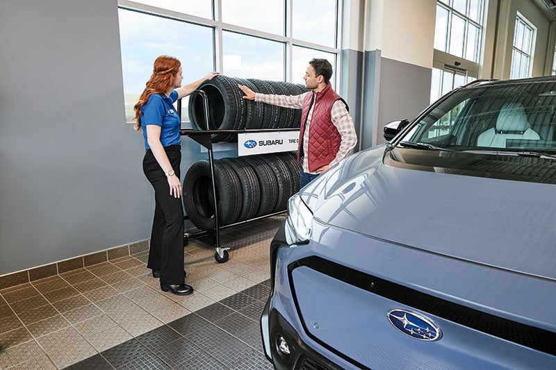service tech with customer and tires Subaru of North Miami in Miami FL