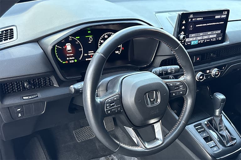 This photo is from a 2024 Used CR-V Hybrid and shows a clean and sophisticated interior dash with touchscreen interface.