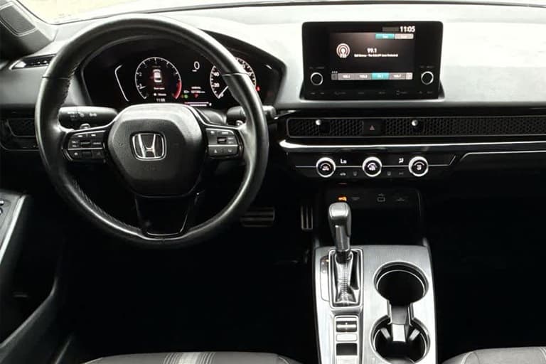 This photo is from a 2024 Used Civic Sport showing the cleanly designed interior dash with interactive touchscreen.